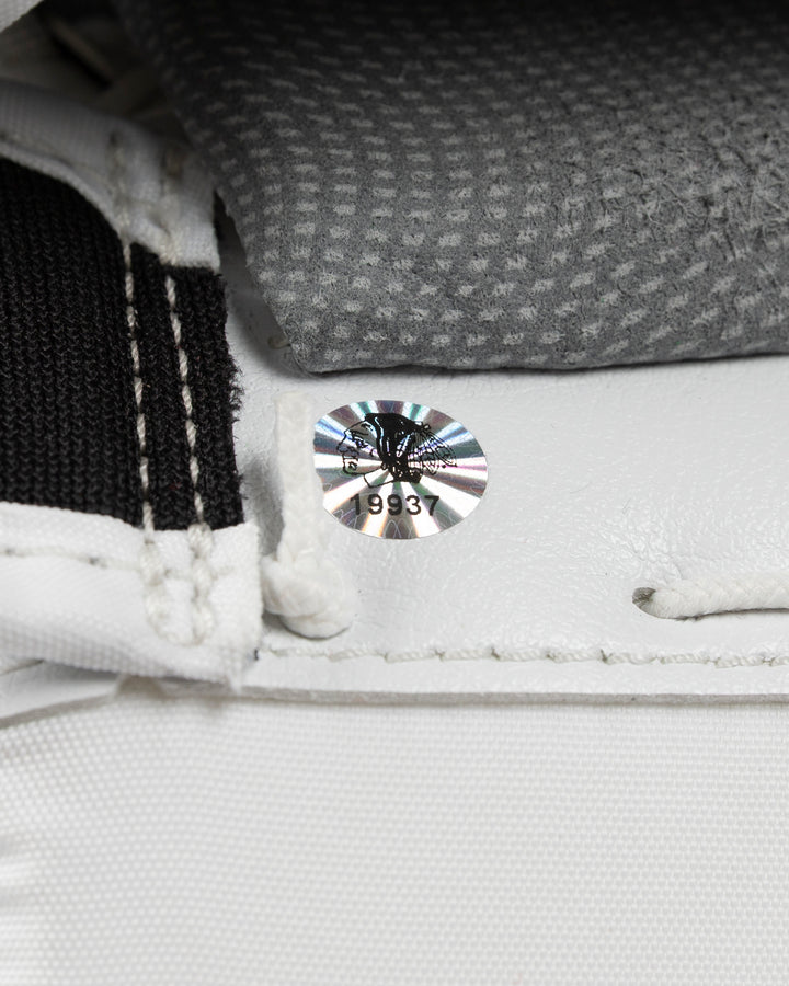white and red Vaughn hockey goalie glove used by Chicago Blackhawks goalie Petr Mrazek - hologram sticker detail lay flat