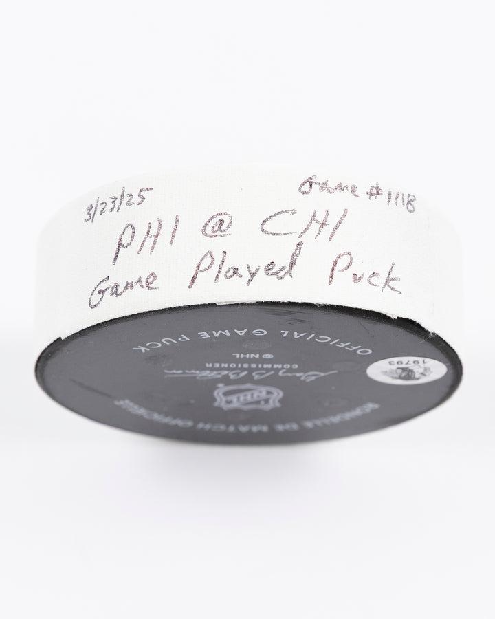 official Chicago Blackhawks hockey puck used in game against Philadelphia Flyers on 3/23/25 - tape detail lay flat