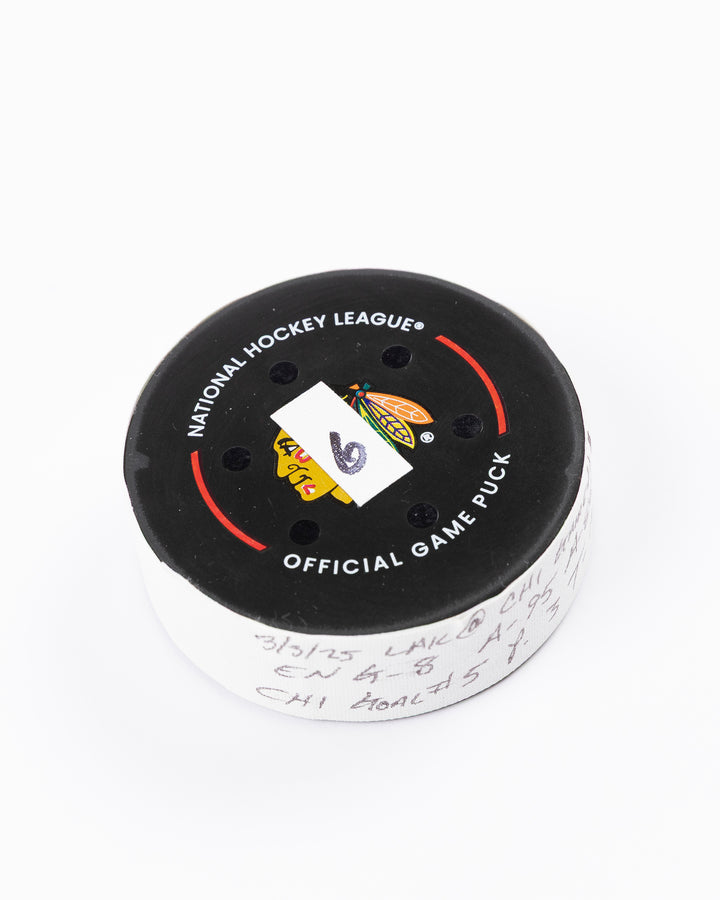 official game used goal puck scored by Chicago Blackhawks player Ryan Donato - front angle lay flat