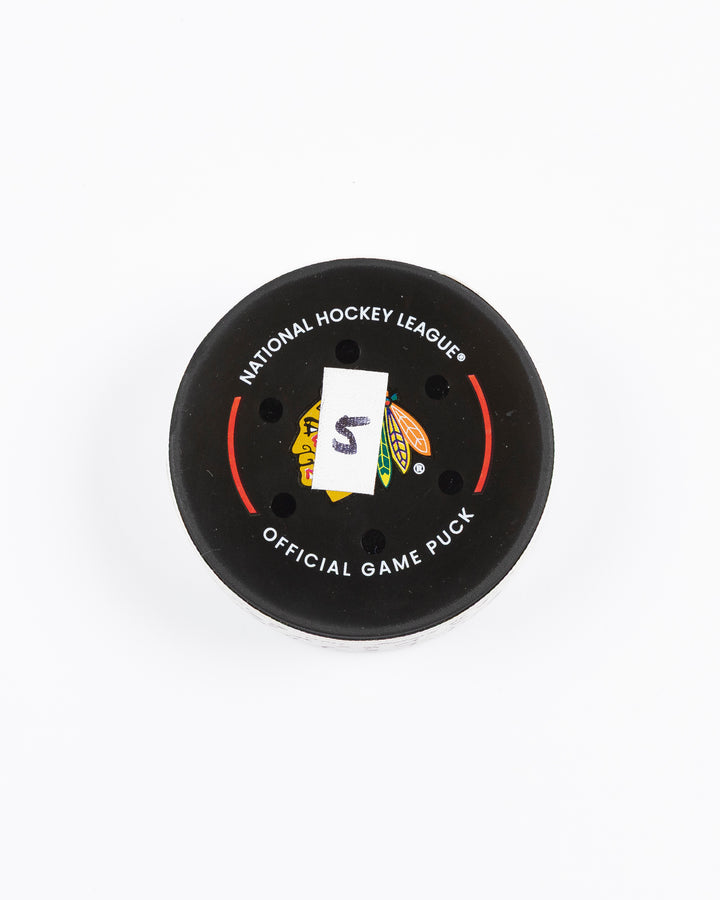 official game used goal hockey puck scored by Chicago Blackhawks player Andreas Athanasiou - front lay flat