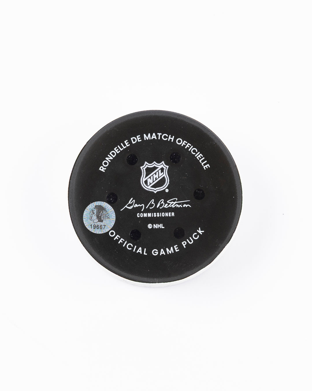 official game used goal hockey puck scored by Chicago Blackhawks player Andreas Athanasiou - back lay flat