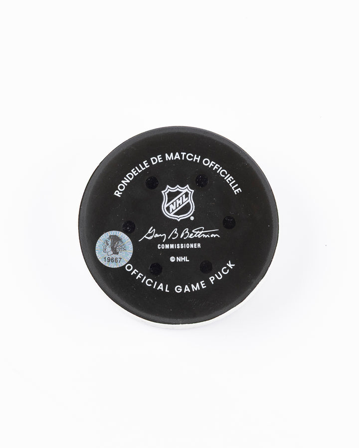 official game used goal hockey puck scored by Chicago Blackhawks player Andreas Athanasiou - back lay flat