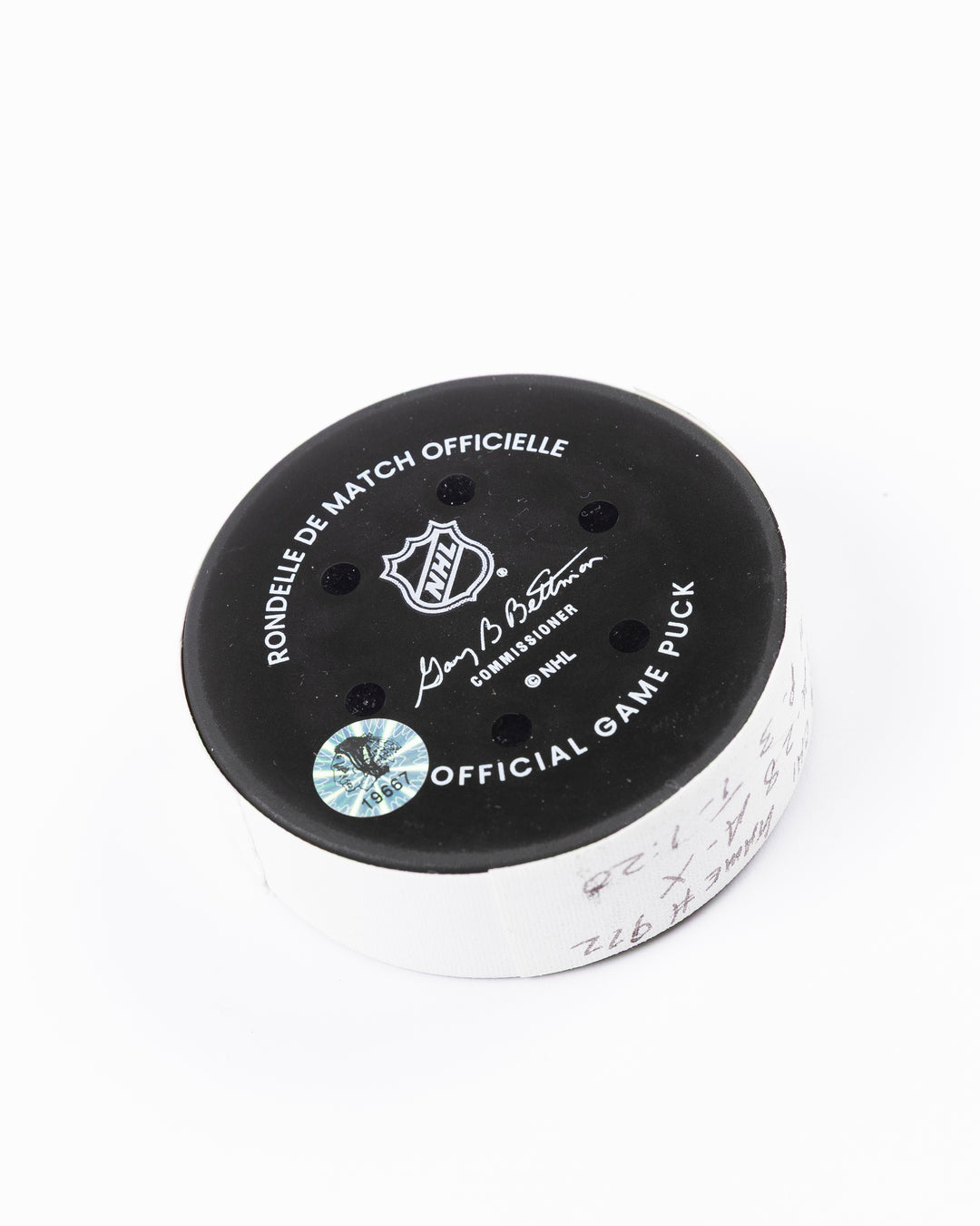 official game used goal hockey puck scored by Chicago Blackhawks player Andreas Athanasiou - back angle lay flat