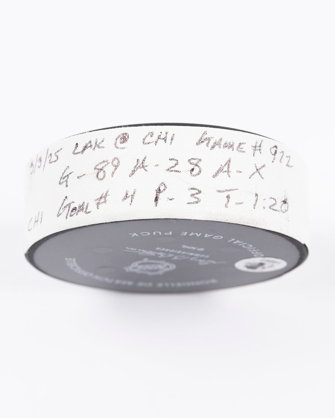 official game used goal hockey puck scored by Chicago Blackhawks player Andreas Athanasiou - tape detail lay flat