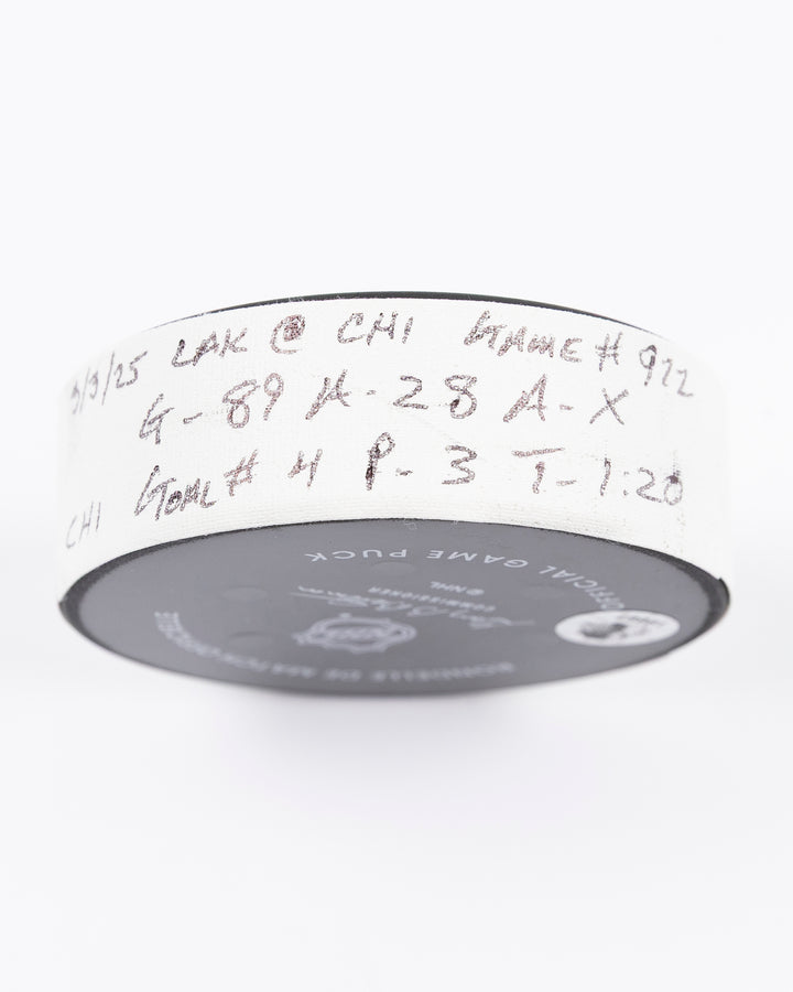 official game used goal hockey puck scored by Chicago Blackhawks player Andreas Athanasiou - tape detail lay flat