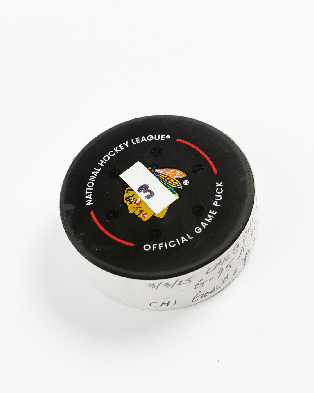 official game used goal puck scored by Chicago Blackhawks player Ilya Mikheyev on 3/3/25 - front angle lay flat