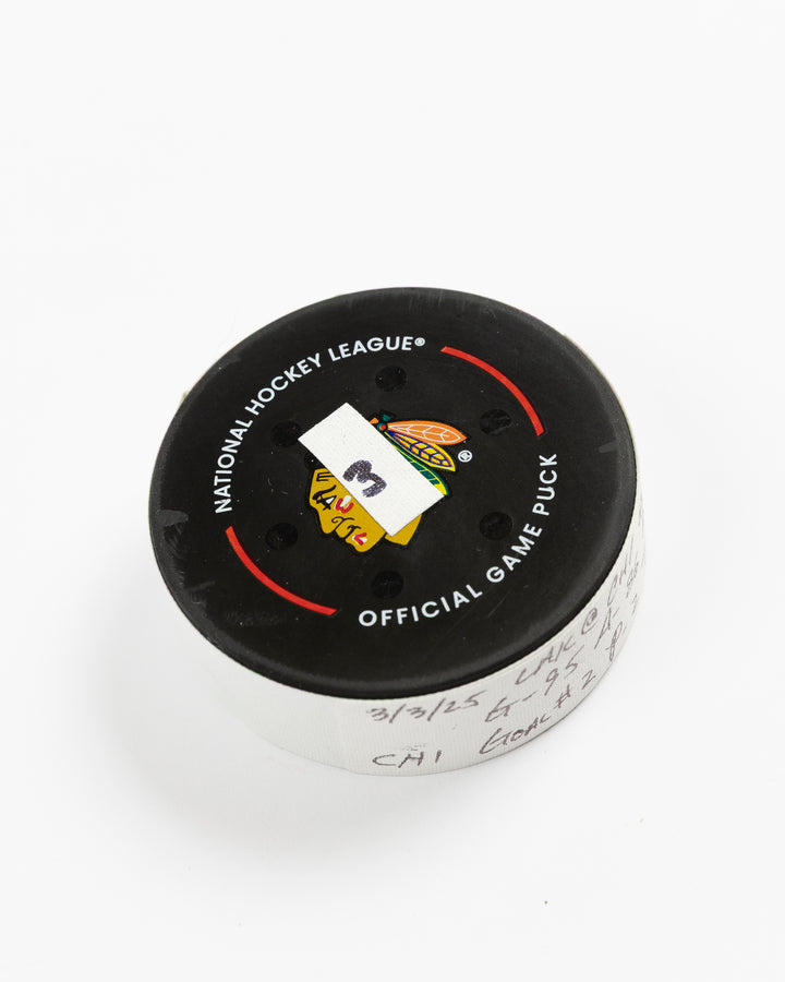 official game used goal puck scored by Chicago Blackhawks player Ilya Mikheyev on 3/3/25 - front angle lay flat
