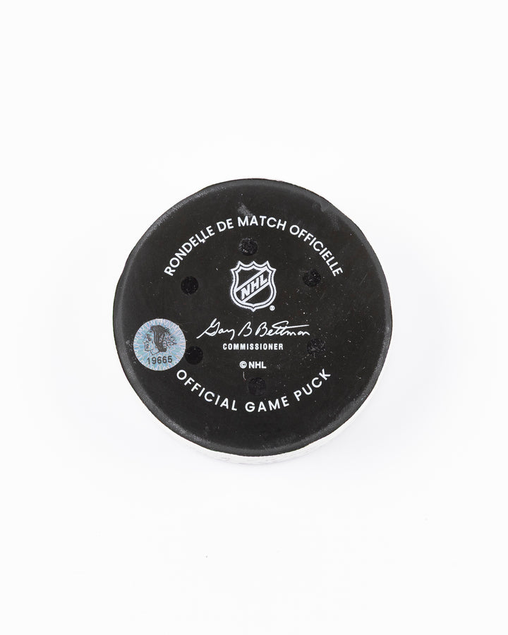 official game used goal puck scored by Chicago Blackhawks player Ilya Mikheyev on 3/3/25 - back lay flat