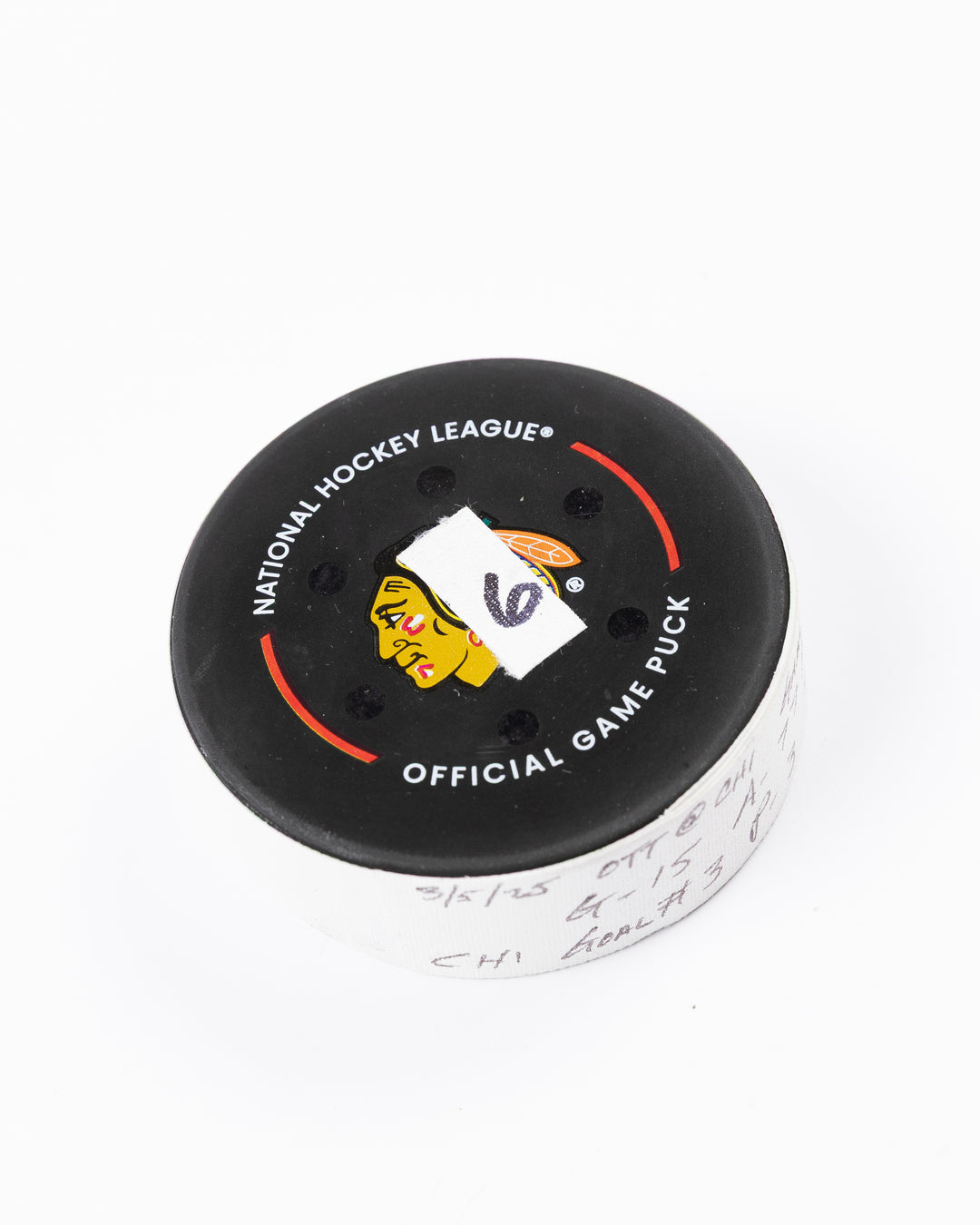 official hockey goal puck scored by Chicago Blackhawks plyer Craig Smith against Ottawa Senators 3/5/25 - front angle lay flat