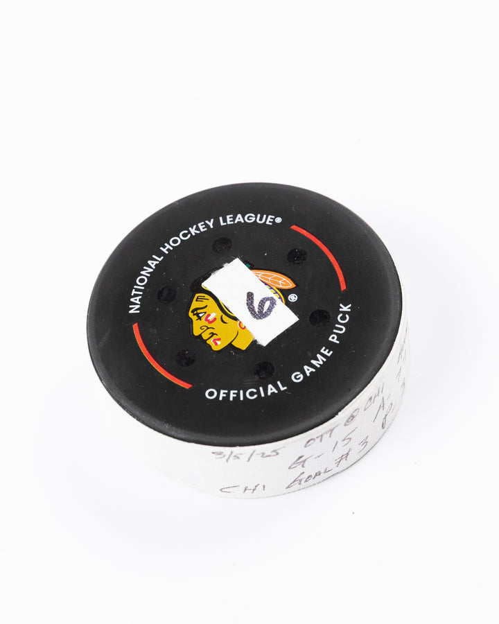 official hockey goal puck scored by Chicago Blackhawks plyer Craig Smith against Ottawa Senators 3/5/25 - front angle lay flat