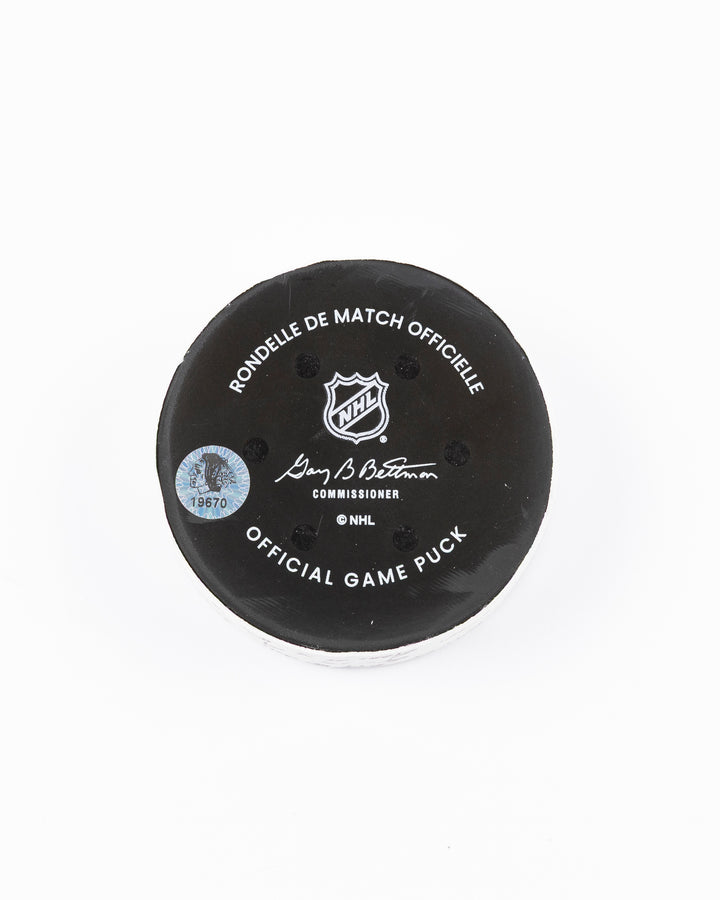 official hockey goal puck scored by Chicago Blackhawks plyer Craig Smith against Ottawa Senators 3/5/25 - back lay flat