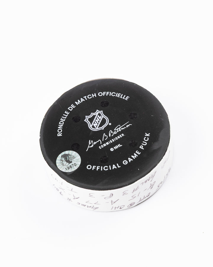 official hockey goal puck scored by Chicago Blackhawks plyer Craig Smith against Ottawa Senators 3/5/25 - back angle lay flat