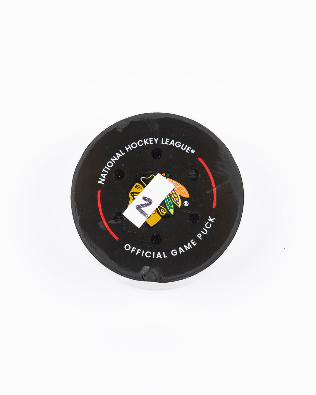 game used hockey goal puck scored by Chicago Blackhawks player Tyler Bertuzzi - front lay flat