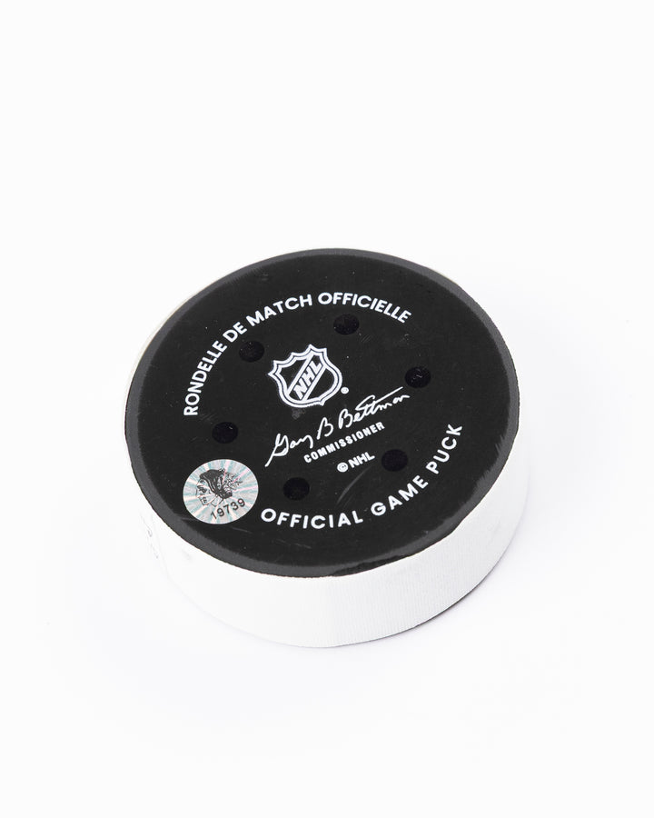 game used hockey goal puck scored by Chicago Blackhawks player Tyler Bertuzzi - back angle lay flat