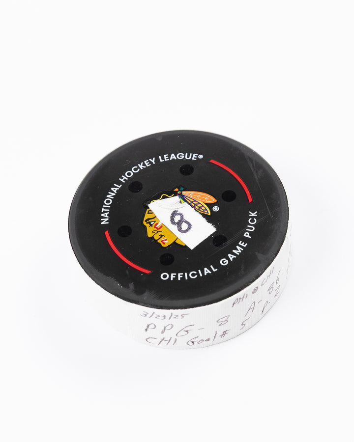 official hockey goal puck scored by Chicago Blackhawks player Ryan Donato 3/23/25 - front angle lay flat