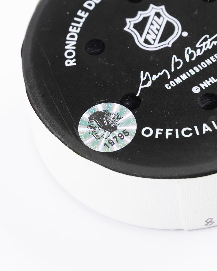 official hockey goal puck scored by Chicago Blackhawks player Ryan Donato 3/23/25 - hologram detail lay flat