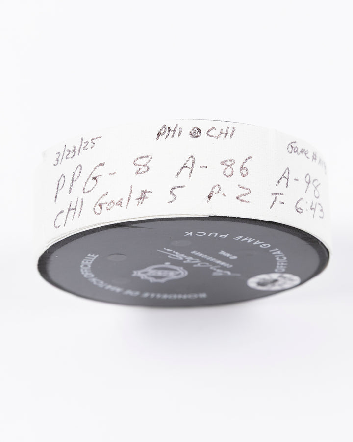 official hockey goal puck scored by Chicago Blackhawks player Ryan Donato 3/23/25 - tape detail lay flat