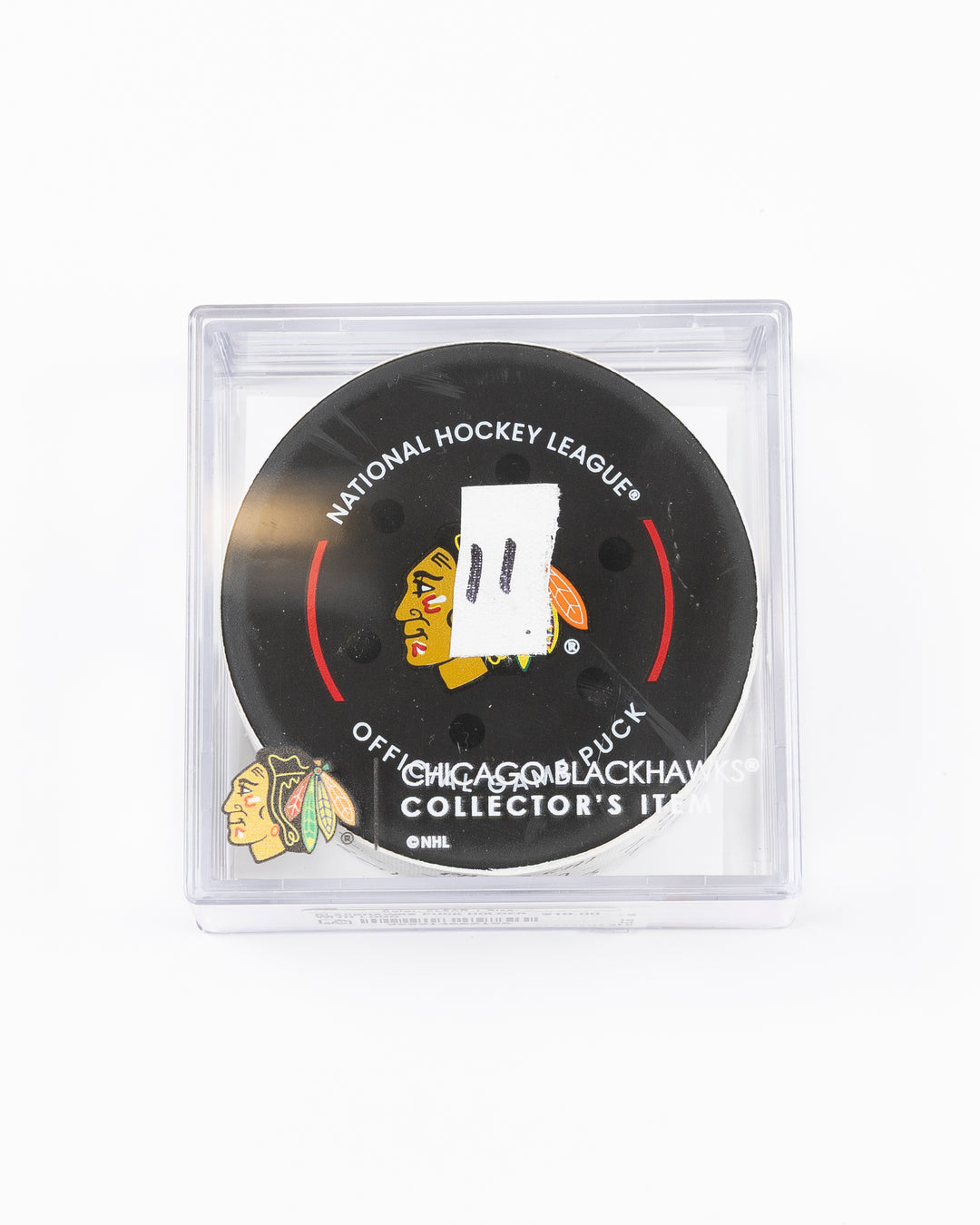 official game used hockey goal puck used by Chicago Blackhawks player Lukas Reichel - front lay flat in case