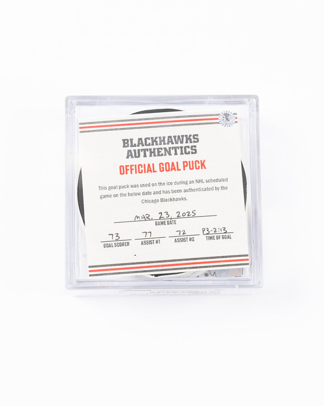 official game used hockey goal puck used by Chicago Blackhawks player Lukas Reichel - front lay flat in case with certificate