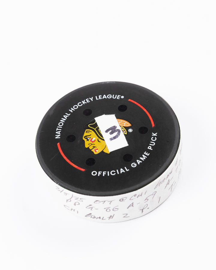 official game used hockey goal puck scored by Chicago Blackhawks player Teuvo Teravainen - front angle lay flat
