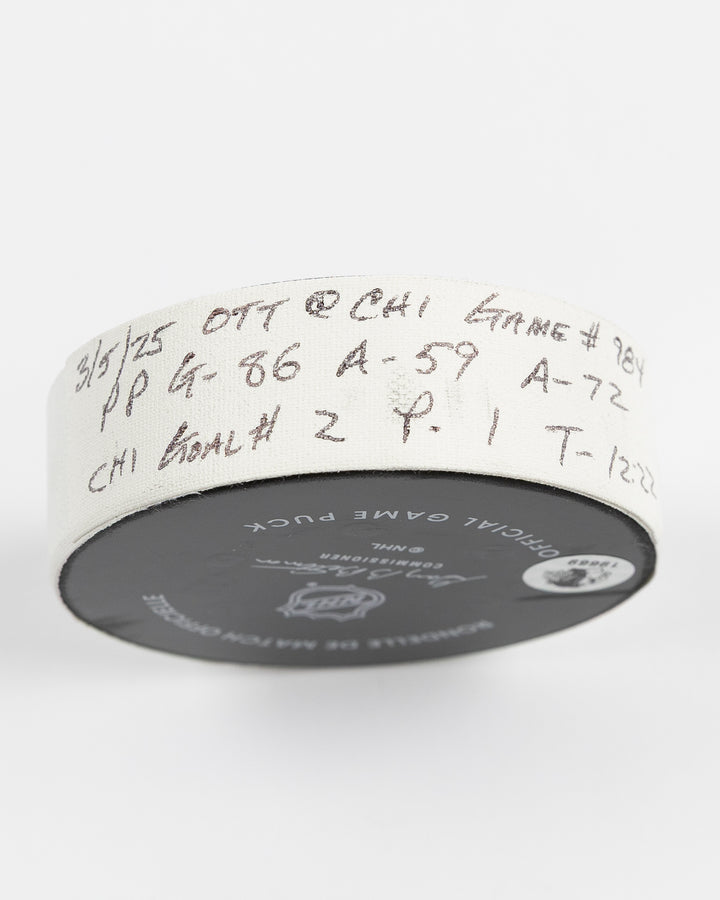 official game used hockey goal puck scored by Chicago Blackhawks player Teuvo Teravainen - tape detail lay flat