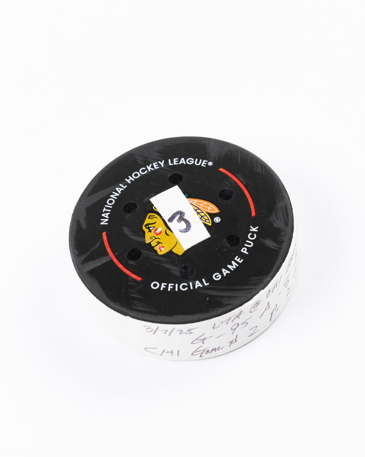 official game used hockey goal puck scored by Chicago Blackhawks player Ilya Mikheyev - front angle lay flat