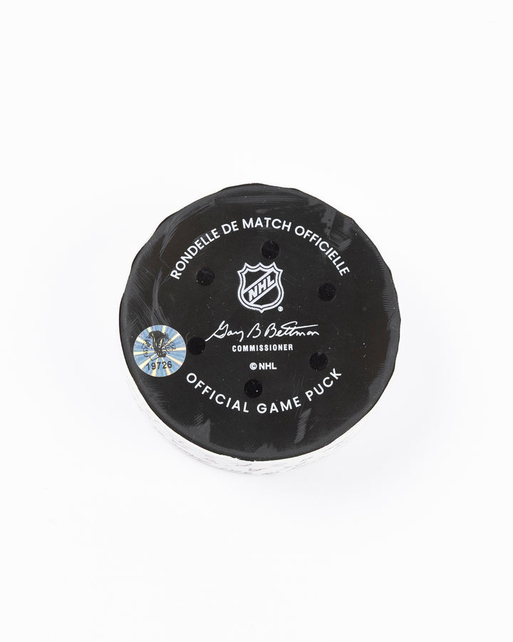 official game used hockey goal puck scored by Chicago Blackhawks player Ilya Mikheyev - back lay flat