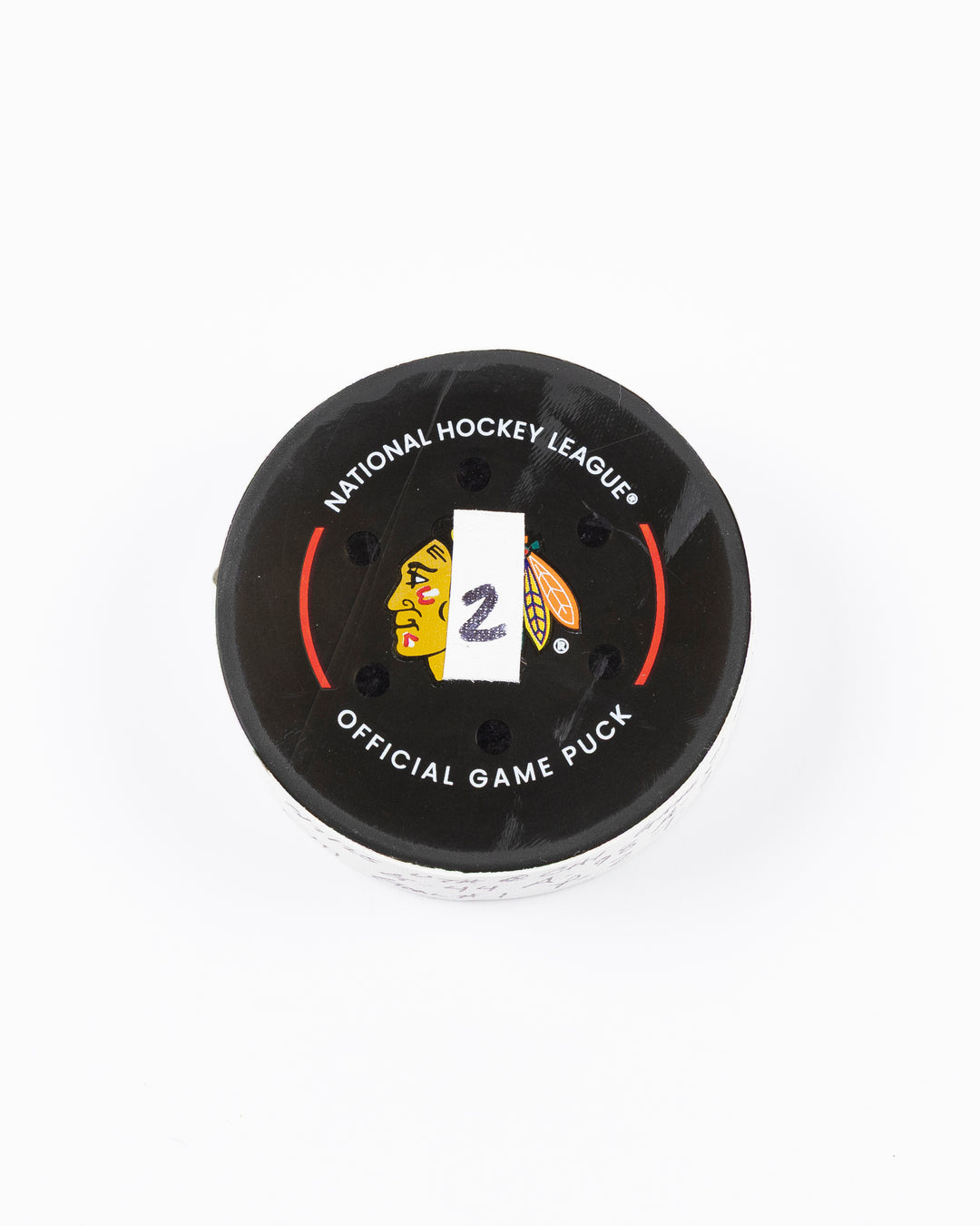 official game used hockey goal puck scored by Chicago Blackhawks player Wyatt Kaiser - front lay flat