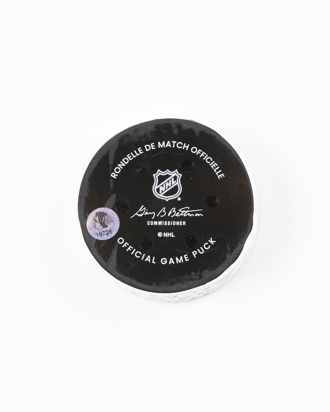 official game used hockey goal puck scored by Chicago Blackhawks player Wyatt Kaiser - back lay flat