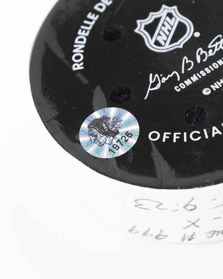 official game used hockey goal puck scored by Chicago Blackhawks player Wyatt Kaiser - hologram sticker detail lay flat