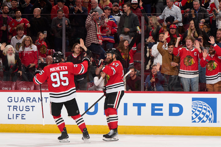 Chicago Blackhawks players Foligno and Mikheyev celebrating after Foligno scored against the Florida Panthers in November 2024 