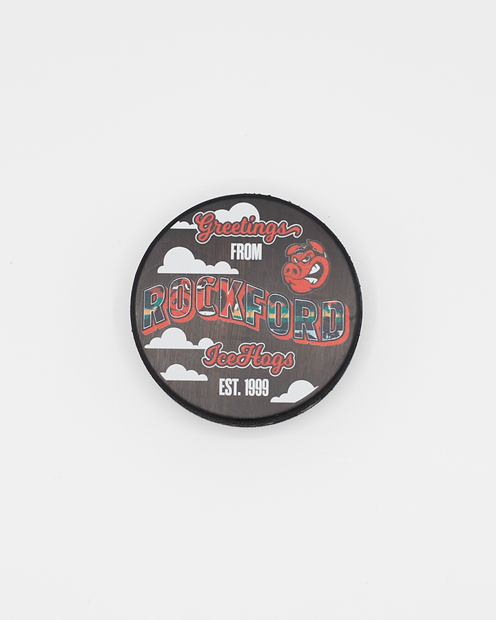 black hockey puch with Greetings from Rockford graphic across front and Rockford IceHogs branding - front lay flat