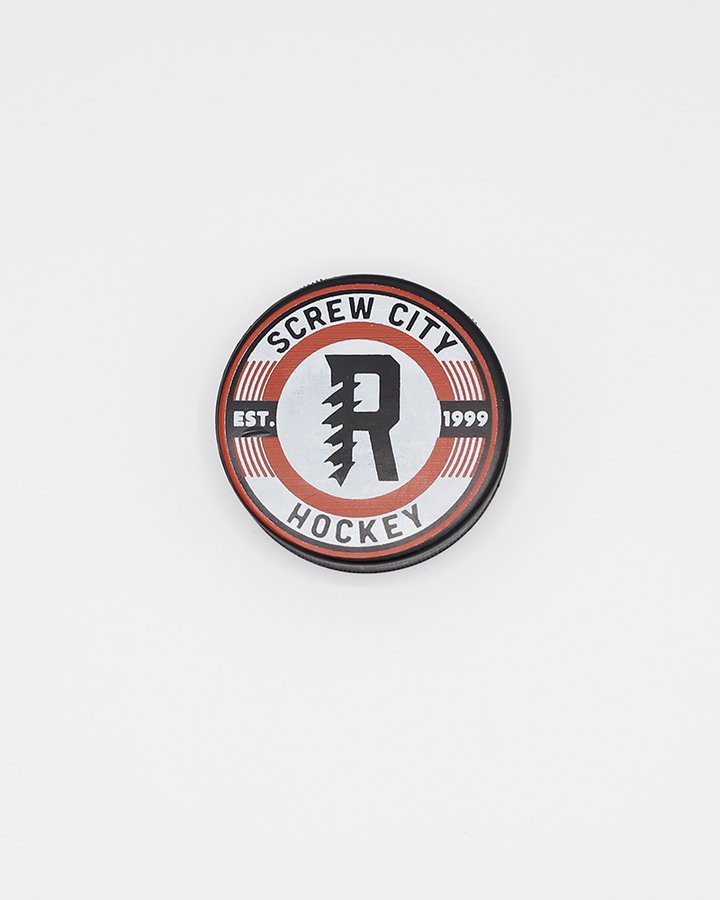 black hockey puck with Screw City Hockey wordmark and R graphic on the front - front lay flat