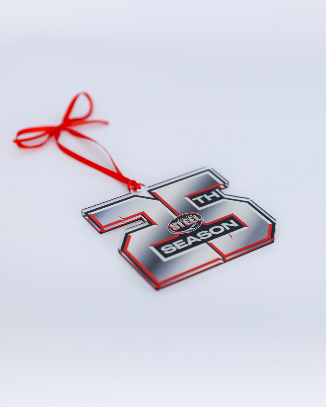 Chicago Steel 25th Anniversary logo holiday ornament - front angled lay flat