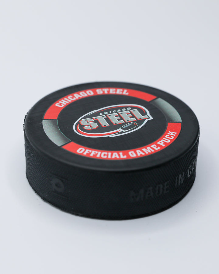 official game hockey puck of the Chicago Steel - angled lay flat