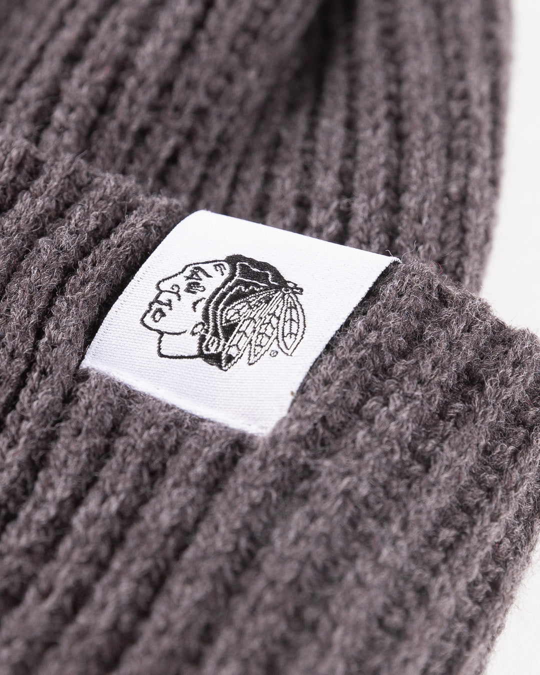 grey ribbed CCM knit hat with Chicago wordmark patch and Chicago Blackhawks primary logo tag on cuff - alt detail lay flat