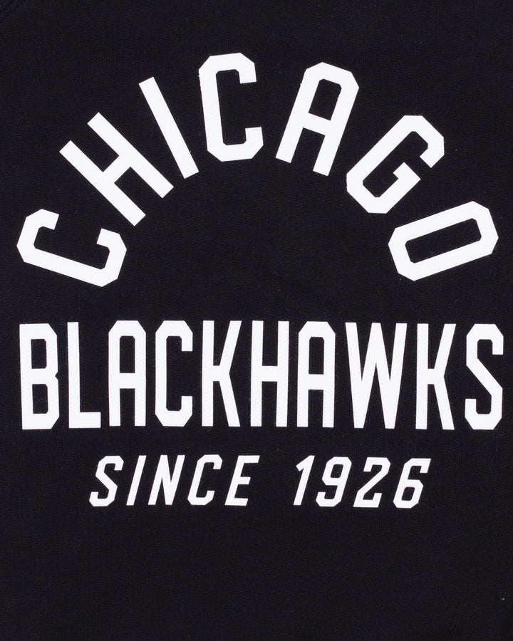 black Sportiqe crewneck with Chicago Blackhawks Since 1926 wordmark across the front - front detail lay flat