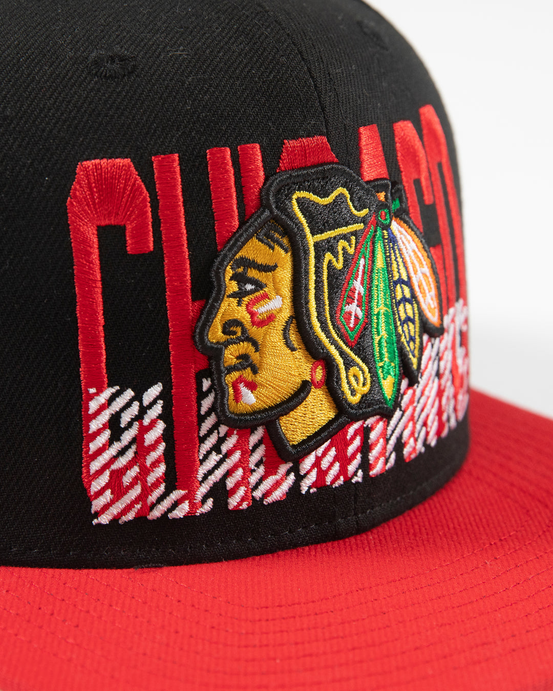 Mitchell & Ness Chicago Blackhawks snapback with red brim and primary logo with cross check wordmark embroidered on front panel - detail lay flat