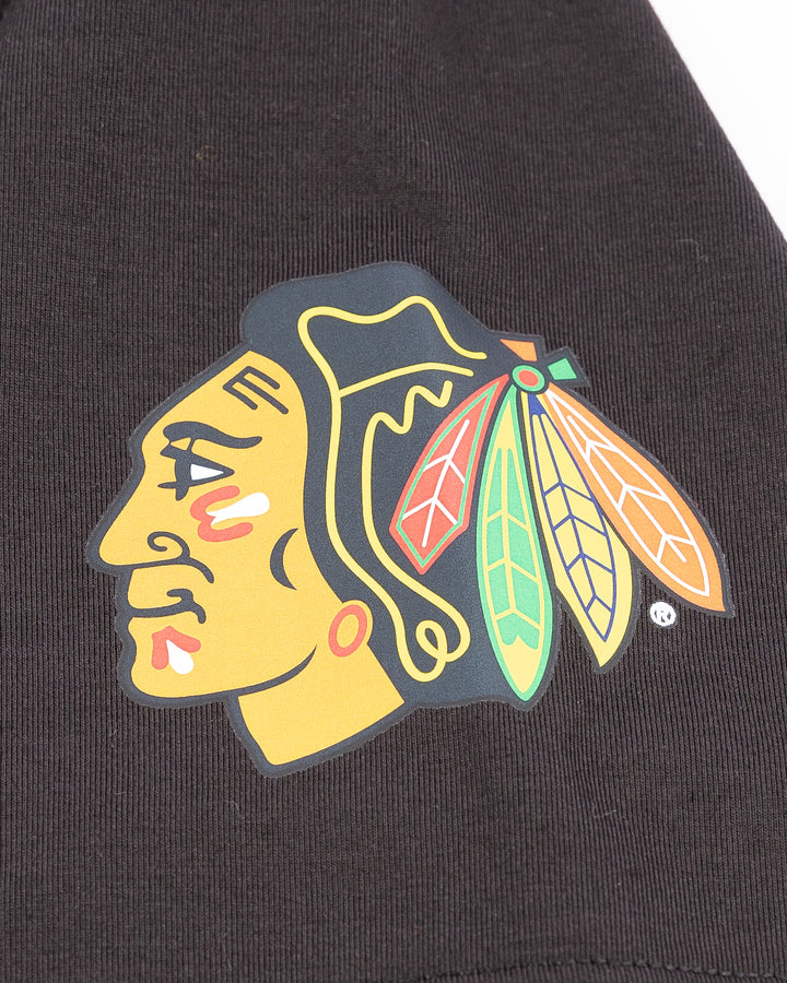 black lululemon tee with Chicago Blackhawks primary logo printed on left shoulder - detail lay flat