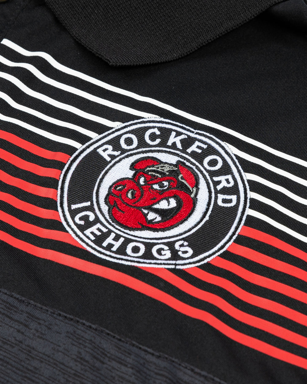 black Colosseum polo with red and white stripes across top and embroidered Rockford IceHogs logo on left chest - detail lay flat 