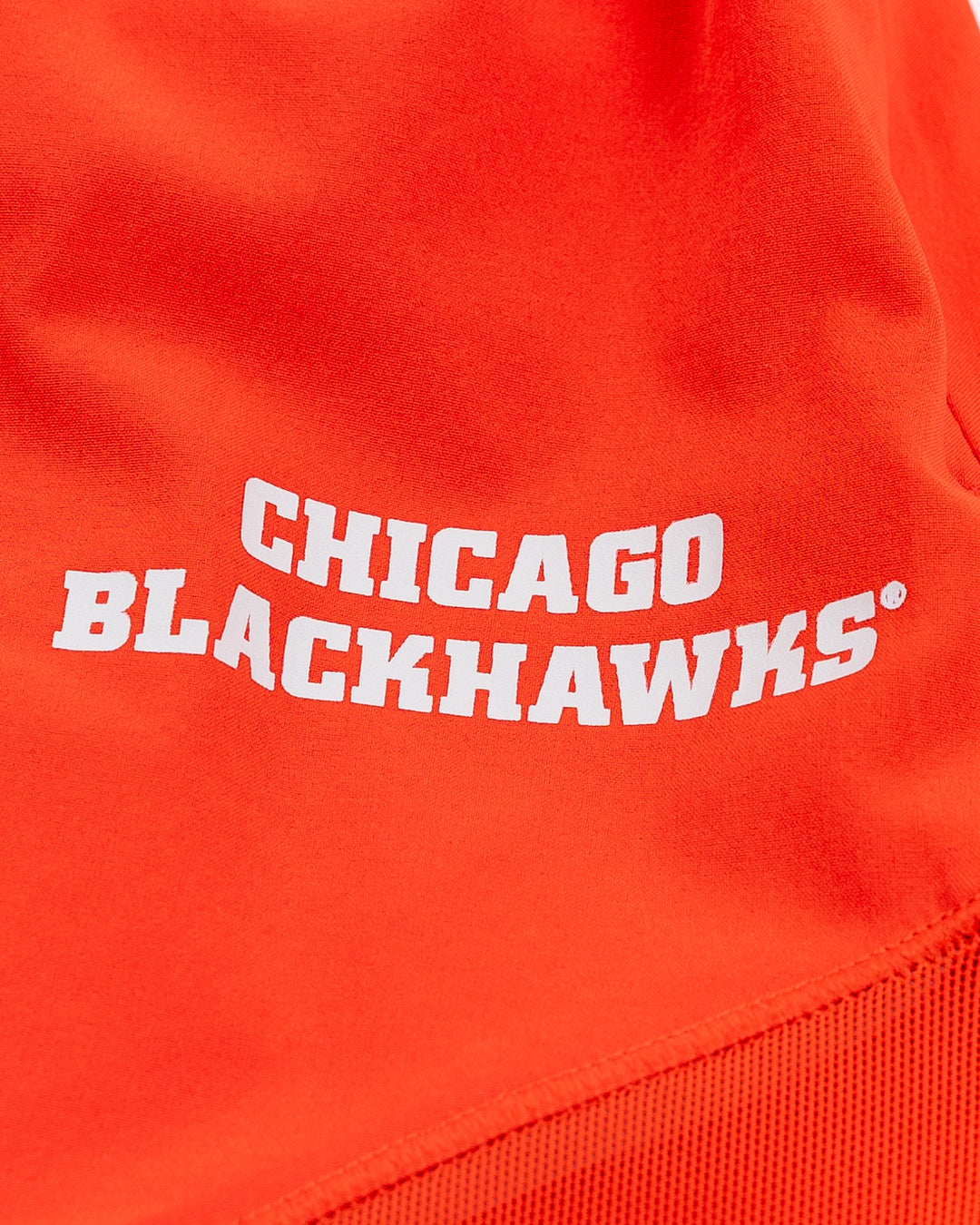 red lululemon shorts with Chicago Blackhawks wordmark on left leg - detail lay flat