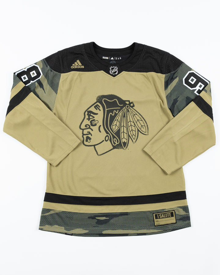 green camo adidas military appreciation Chicago Blackhawks jersey with pro stitched Connor Bedard name and number - front lay flat