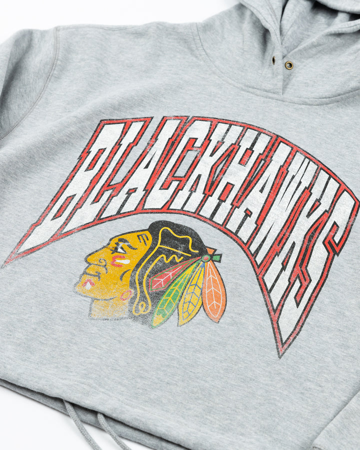 grey women's '47 brand cropped hoodie with Chicago Blackhawks wordmark and primary logo across front - detail lay flat