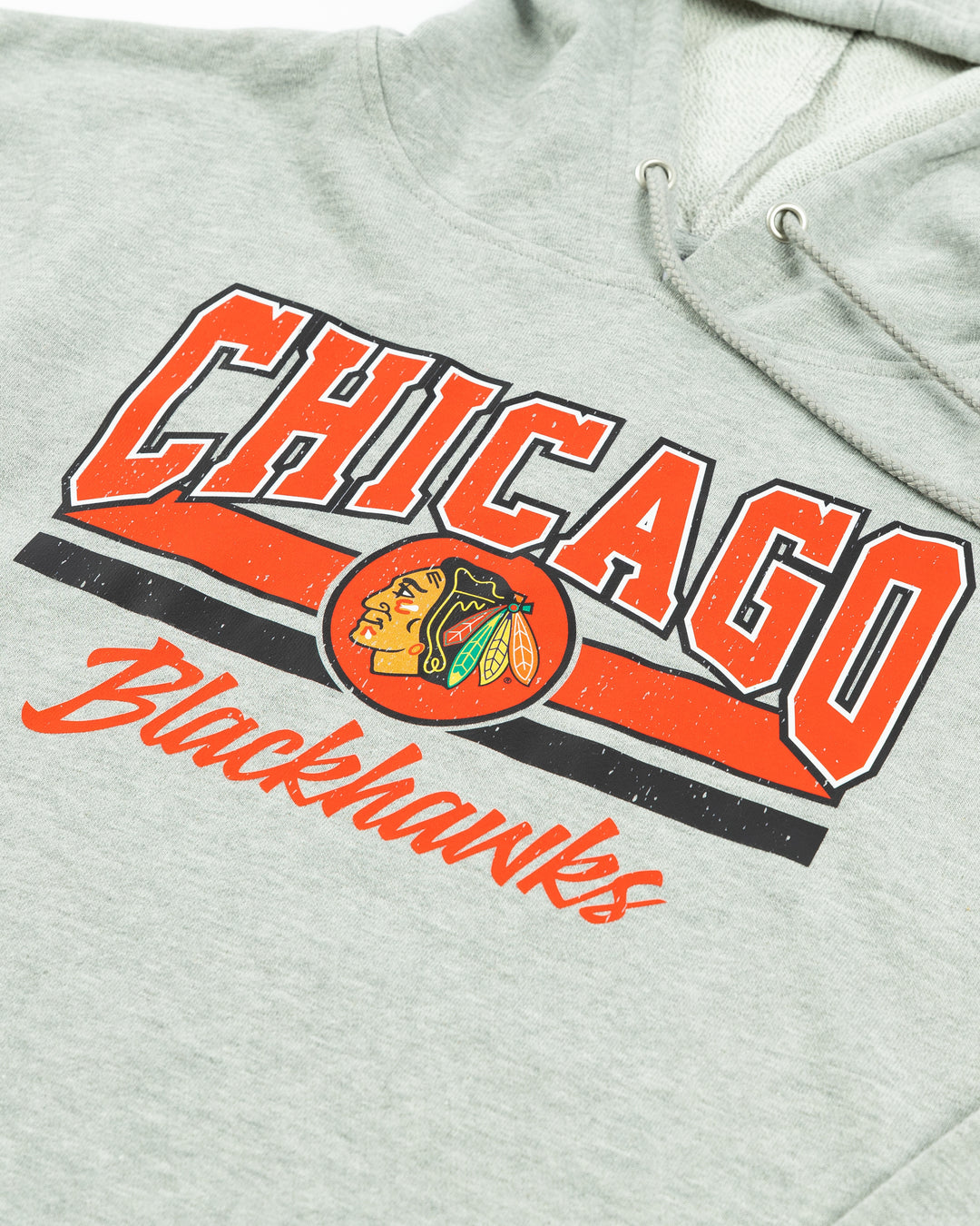 grey cropped ladies hoodie with Chicago Blackhawks wordmark and primary logo graphic across the front - detail lay flat