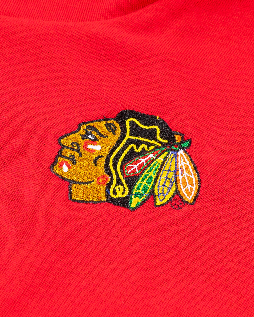 red half zip jacket with oversized collar and embroidered Chicago Blackhawks primary logo on left chest - detail lay flat