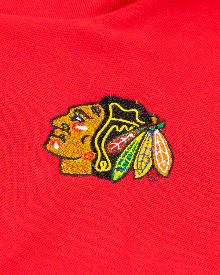 red half zip jacket with oversized collar and embroidered Chicago Blackhawks primary logo on left chest - detail lay flat