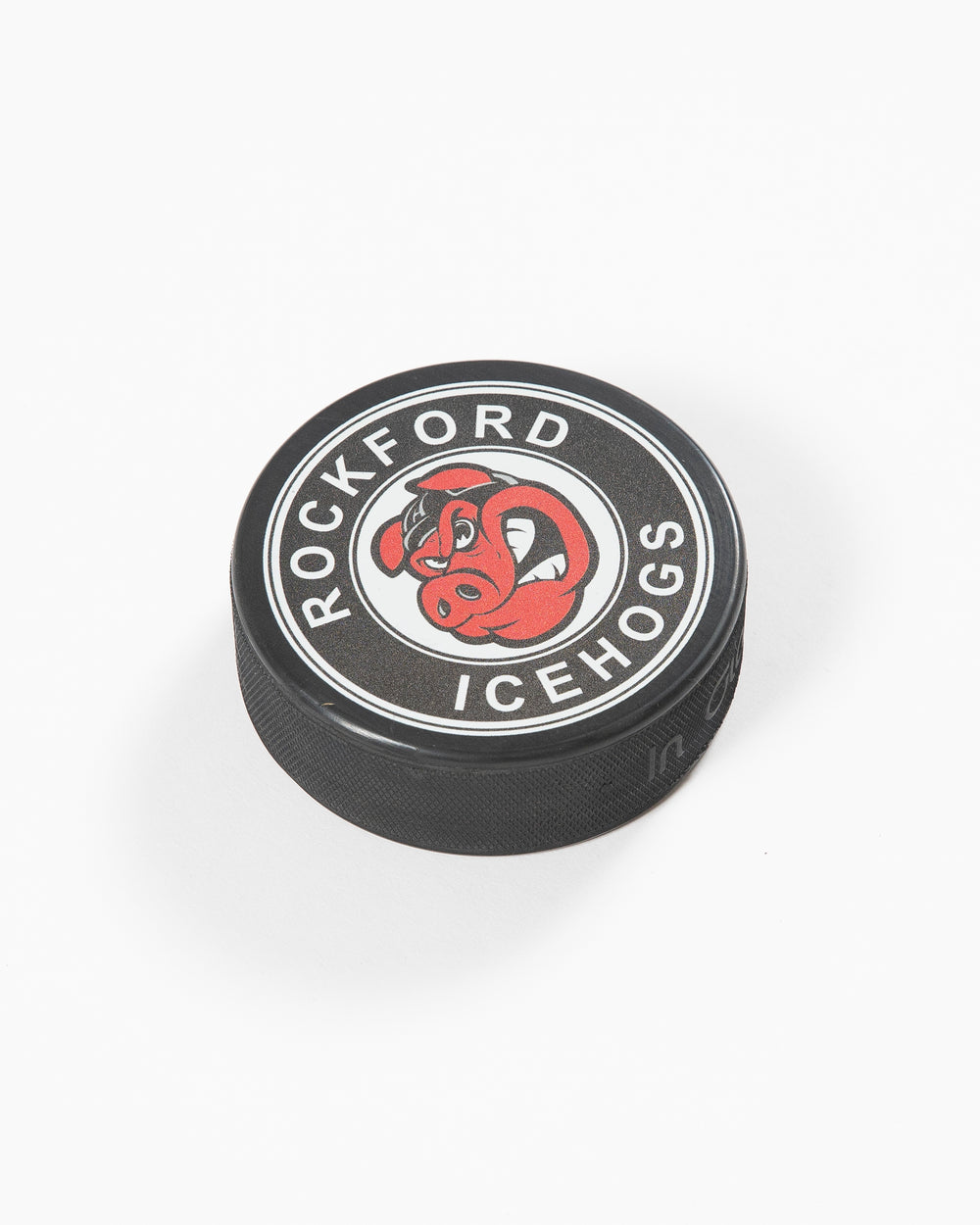 black hockey puck with Rockford IceHogs logo on front - angled lay flat