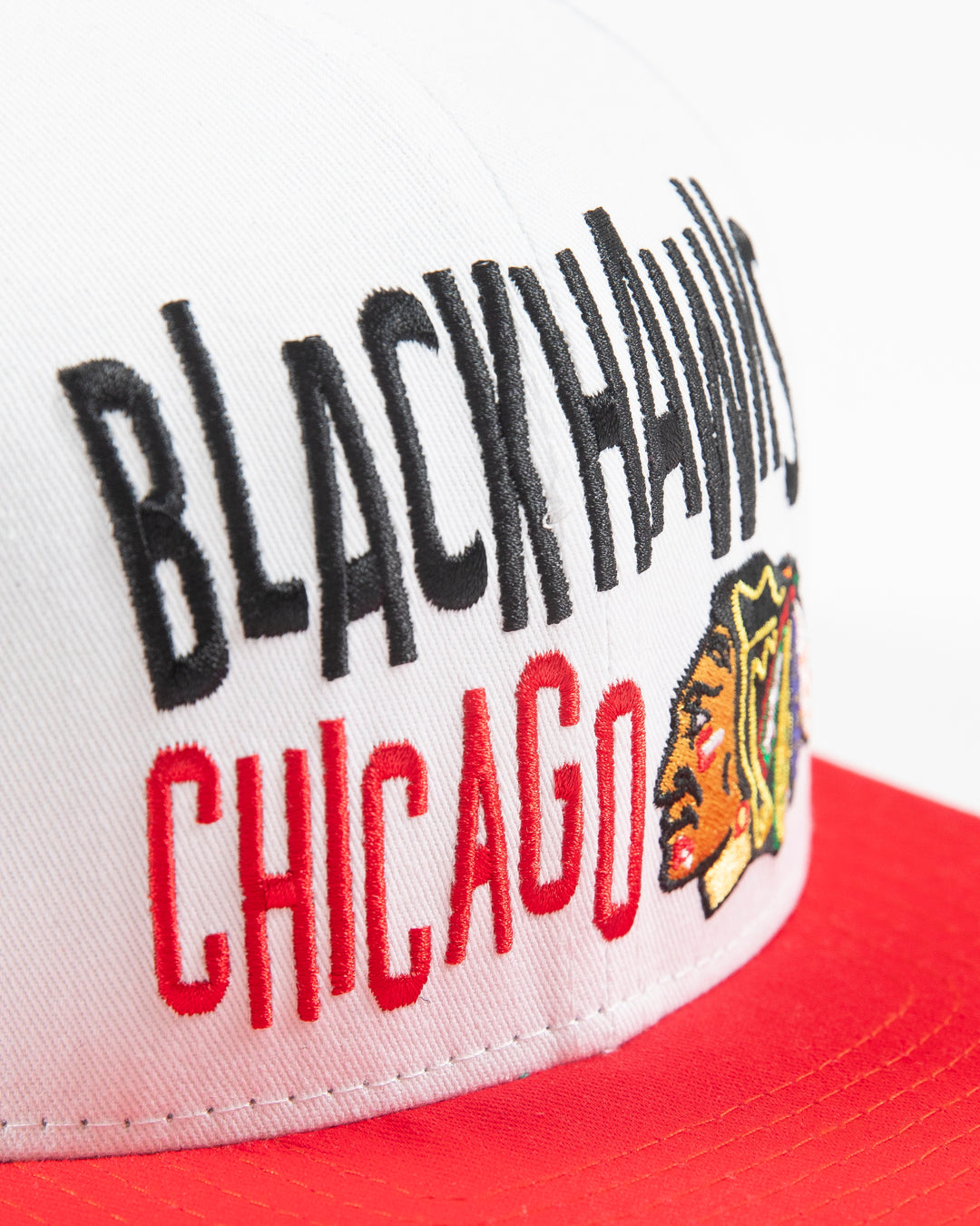 white and red Mitchell & Ness youth snapback with Chicago Blackhawks wordmark and primary logo embroidered on front - detail lay flat