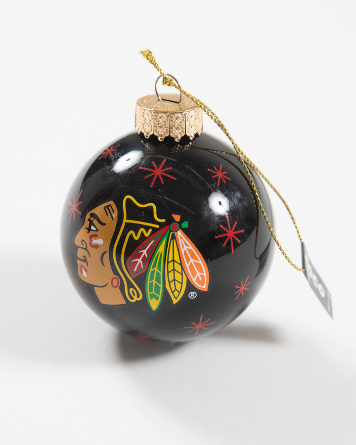 black holiday ornament with Chicago Blackhawks primary logo and red snowflake designs all over - angled lay flat