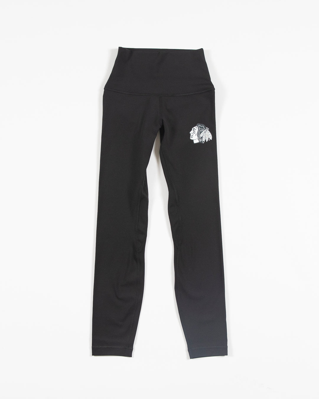 Black lululemon leggings with white tonal Chicago Blackhawks primary logo on left thigh - front lay flat